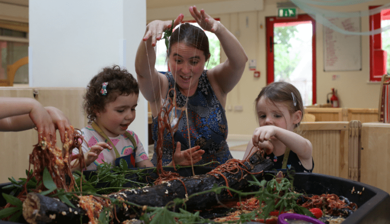 Staff and children messy play with slime