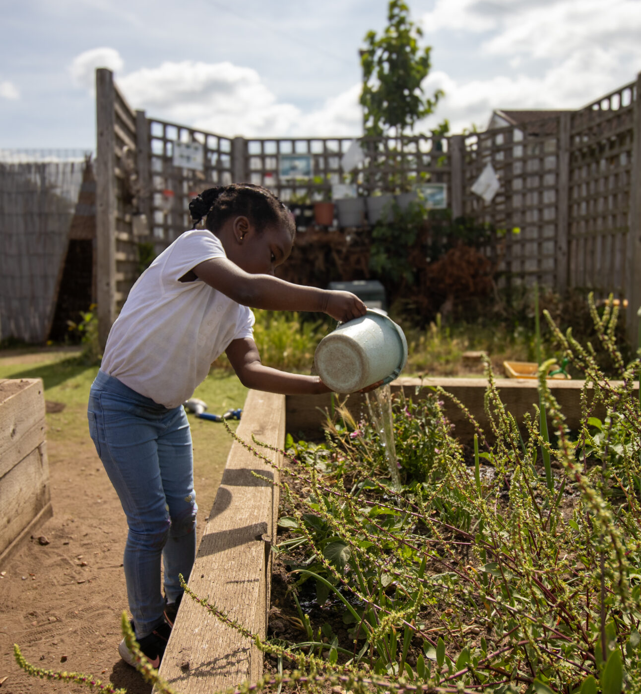 Child watering plant