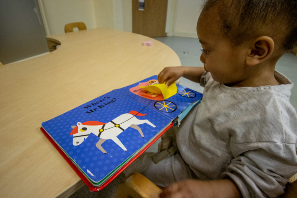 Reading a picture book at LEYF Stockwell Gardens