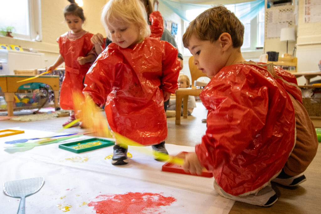 Playing with paint at LEYF Old Kent Road Nursery