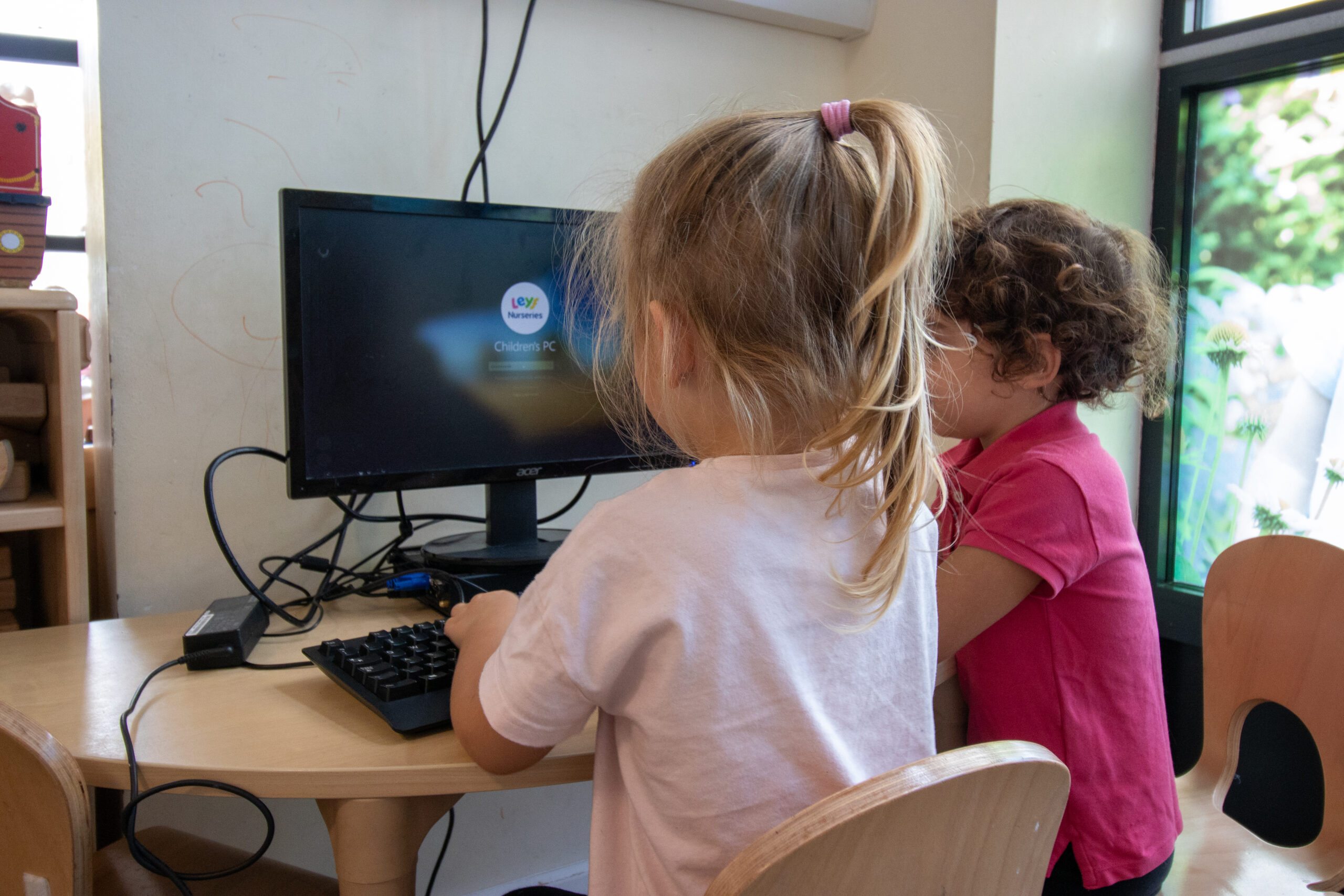 Learning to use at computer at LEYF Thames Reach
