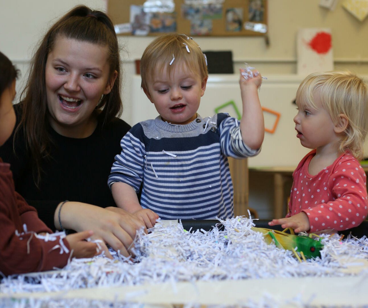 Children playing with shredded paper