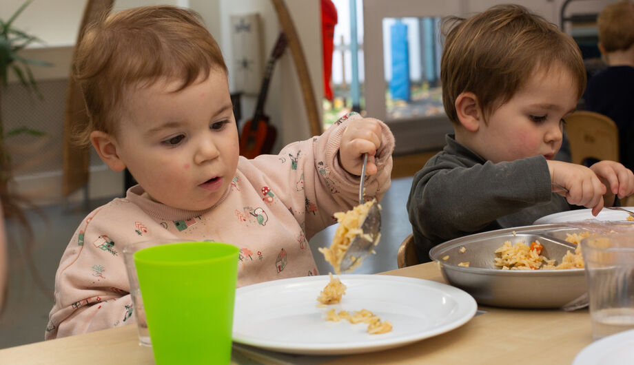 A small child serving themselves lunch