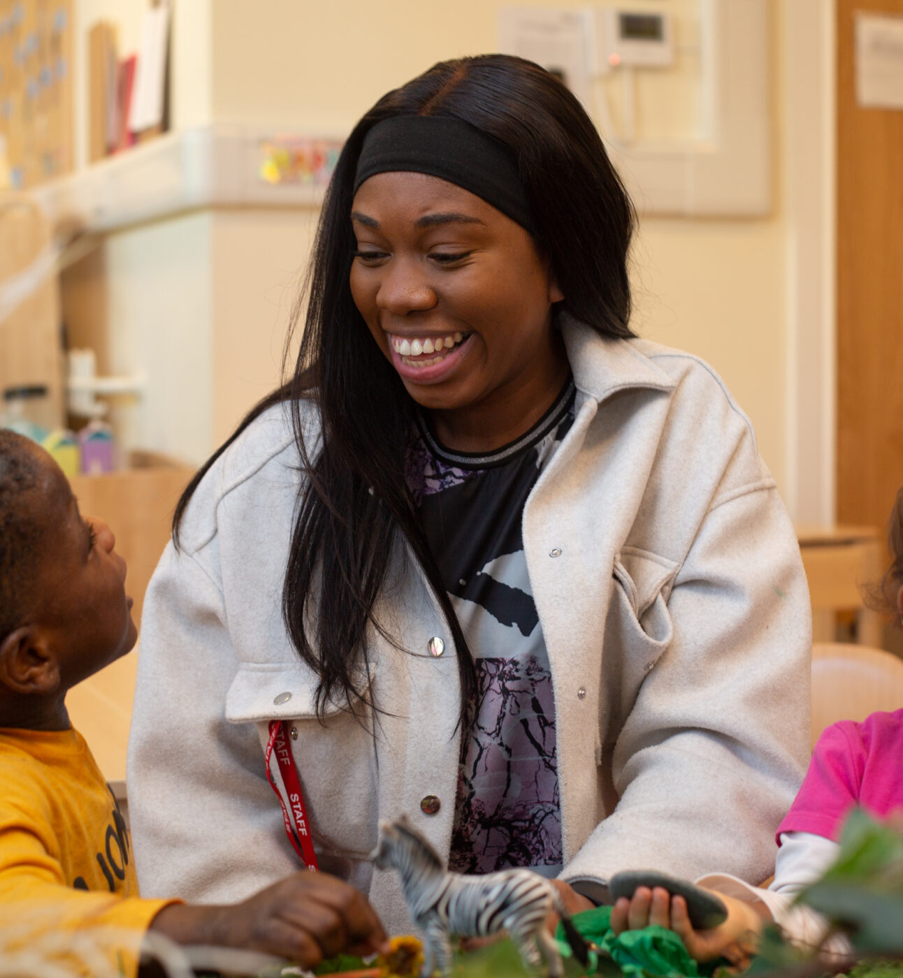 Teacher smiling at a child