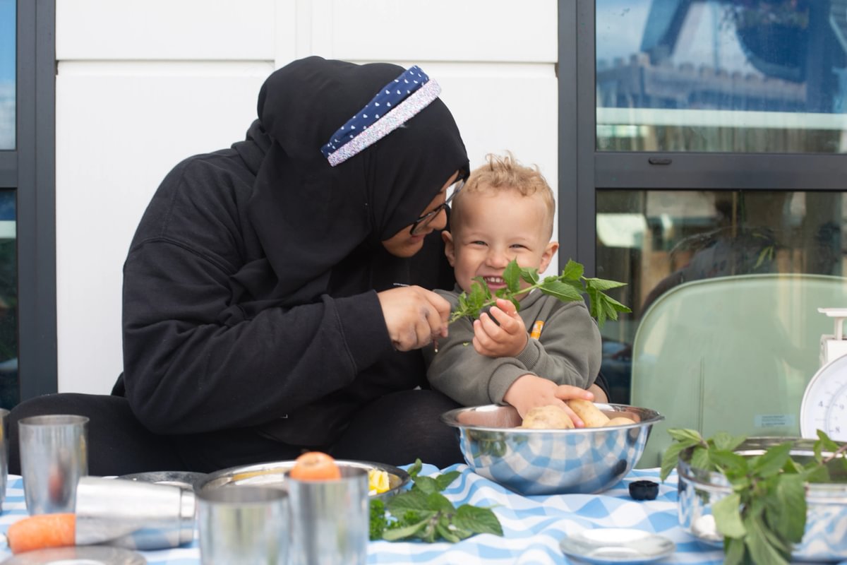 Cookery outdoor activity with teacher educator and child