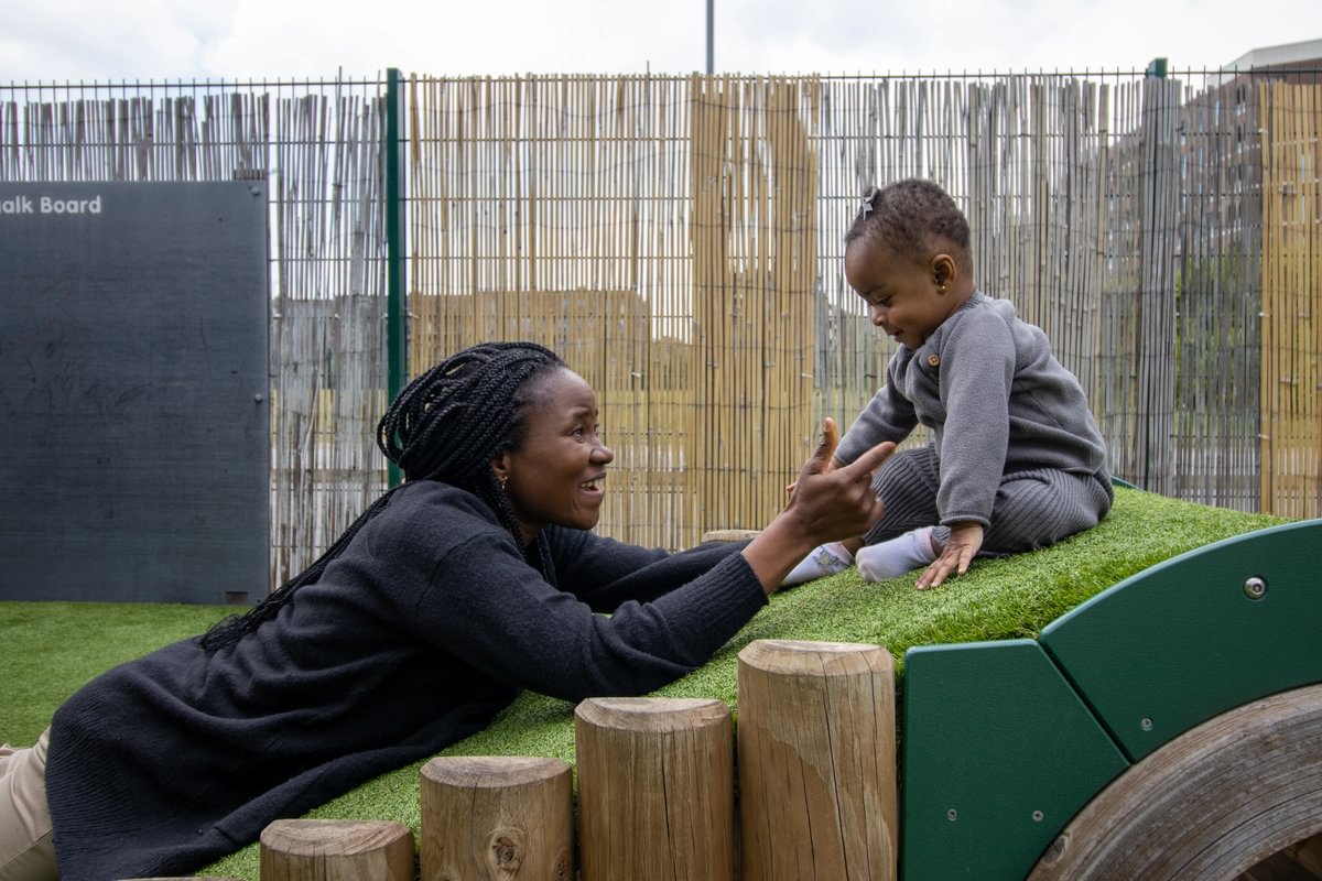 Baby going down the obstacle course with encouragement