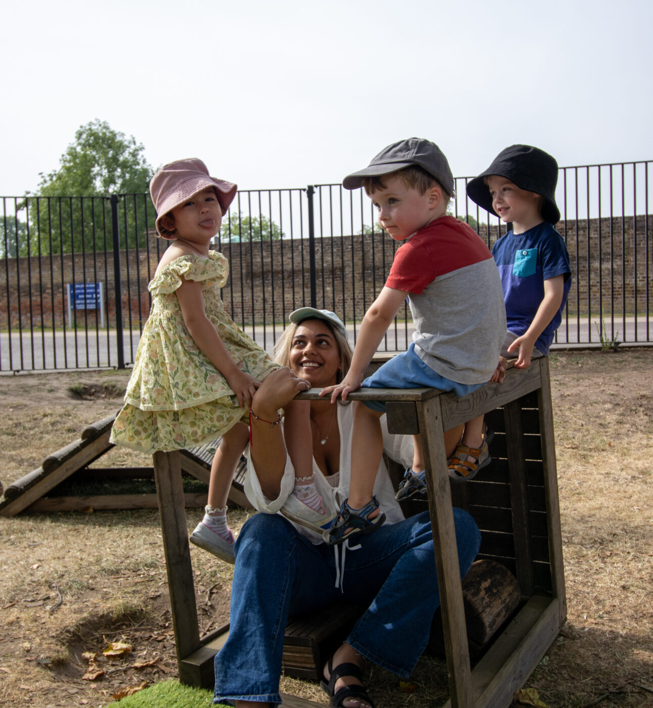 Pre-Schoolers in the garden singing songs on a structure