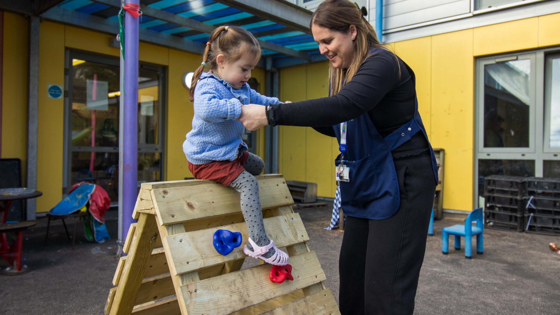 South Bermondsey Nursery Practitioner Teacher Educator with child on climbing frame.
