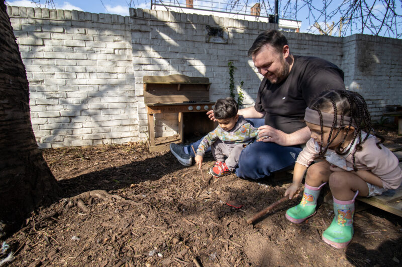 Burgess Park Teacher Manager Educator Practitioner playing in mud with children.